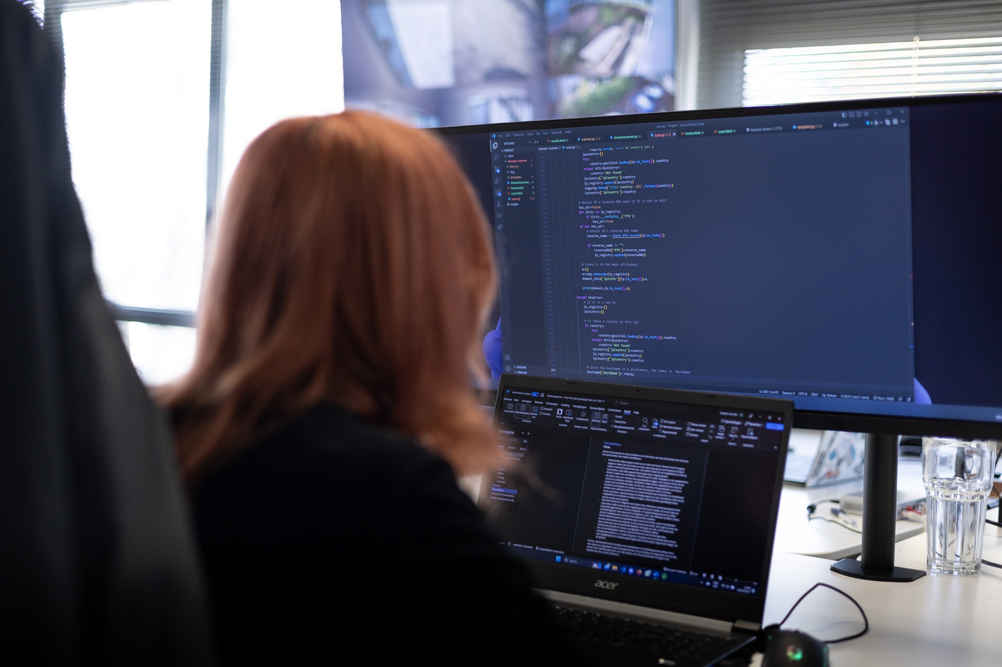 Rootsec engineer reviewing source code on a large monitor during a security test