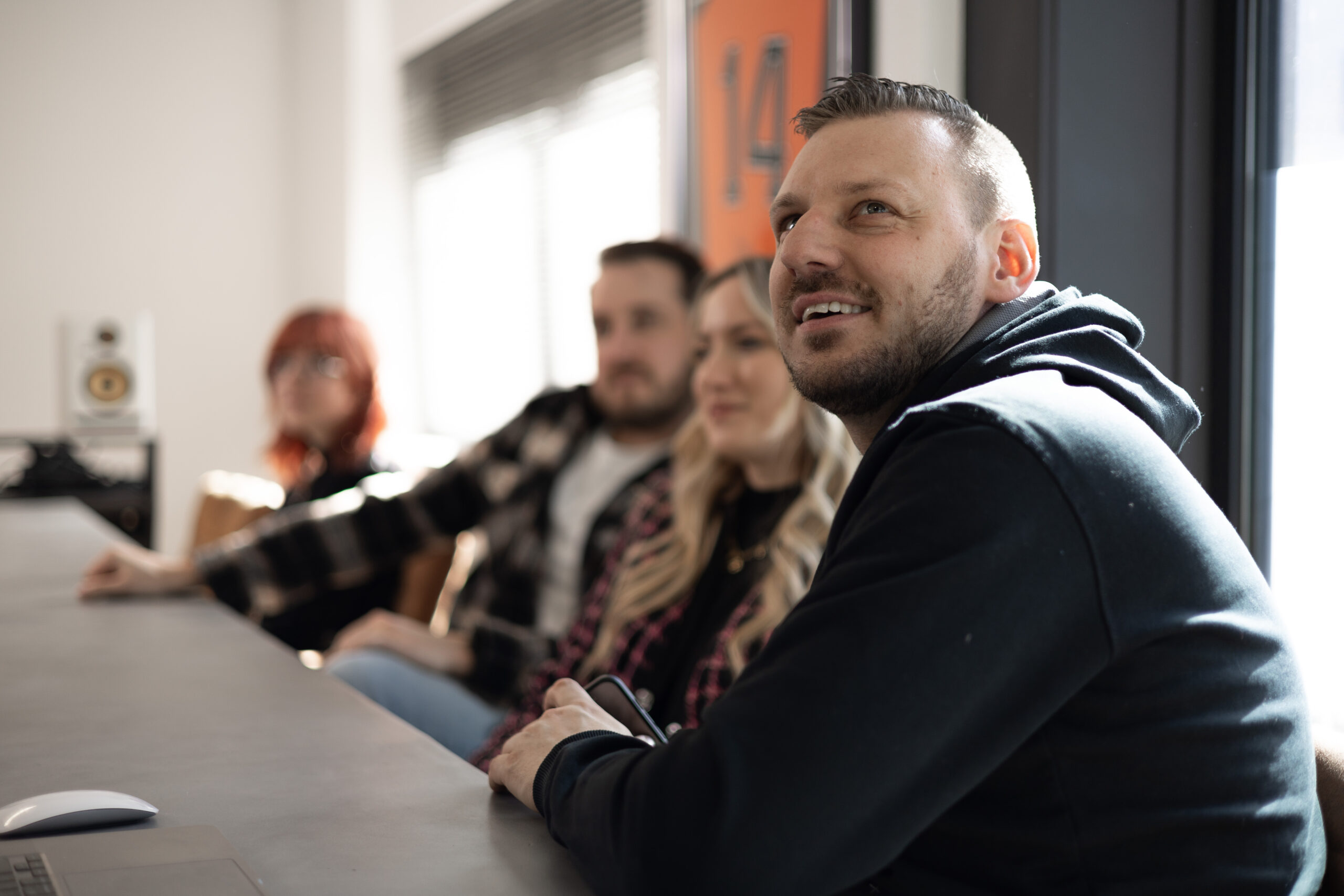 Rootsec team members listening during a meeting in the office